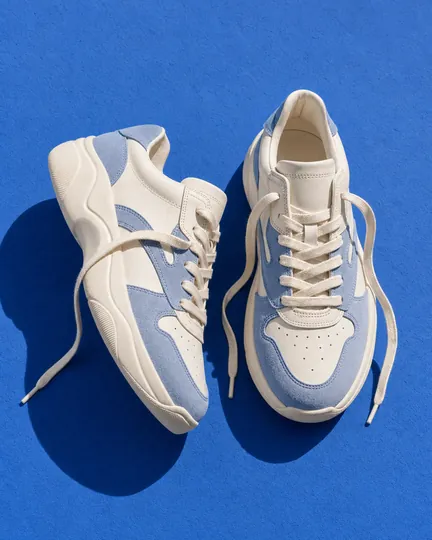 DTC sneaker brand creative: pair from above, laces undone.
