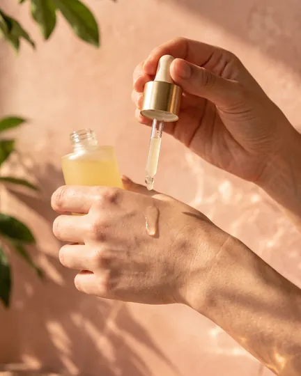 DTC skincare brand creative: applying one drop to the hand.