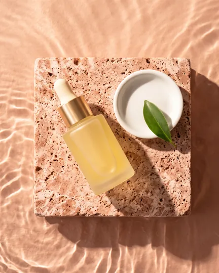 DTC skincare brand creative: bottle, dish and leaf from above.